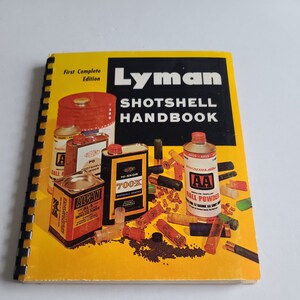 May include: A yellow book titled "Lyman Shotshell Handbook: First Complete Edition" with a cover image of various shotgun shells, powder canisters, and shot.