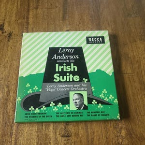 May include: A vintage vinyl record album cover featuring a green shamrock design and a portrait of Leroy Anderson. The album title is "Leroy Anderson conducts his Irish Suite" with the subtitle "Leroy Anderson and his "Pops" Concert Orchestra". The album includes the songs "Irish Washerwoman", "The Wearing of the Green", "The Last Rose of Summer", "The Girl I Left Behind Me", "The Minstrel Boy", and "The Rakes of Mallow".