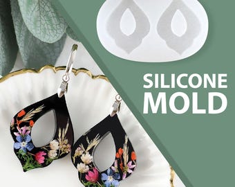 Könnte beinhalten: Schwarze Tropfenohrringe mit bunten Trockenblumen und silbernen Haken. Gezeigt wird auch eine weiße Silikonform mit passender Tropfenform. Der Text "SILICONE MOLD" ist in Weiß dargestellt.