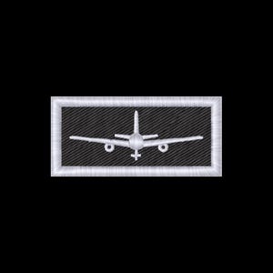 May include: Embroidered patch featuring a white airplane design on a black background. The airplane is centered within a rectangular frame with a white border. The patch is likely for clothing or accessories.