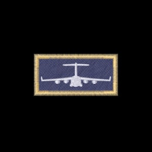 May include: A rectangular embroidered patch featuring a dark blue fabric background with a white stitched silhouette of a cargo airplane. The patch is bordered by a thick, textured gold-colored thread edge that frames the central design.