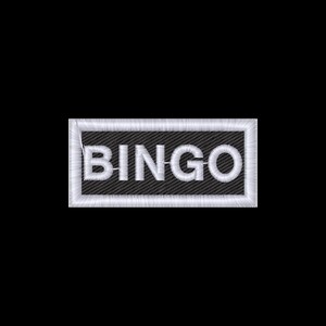 May include: Embroidered patch with the word "BINGO" in white thread. The text is centered on a black rectangular background with a white border. The patch is likely for clothing or accessories.