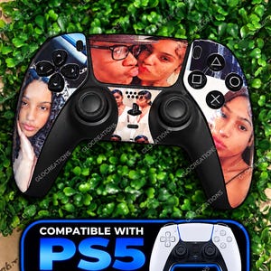 May include: A black video game controller featuring custom photo prints of people on the front faceplate. The controller includes standard black analog sticks, a directional pad, and action buttons. A blue graphic label reads COMPATIBLE WITH PS5 DUALSENSE.