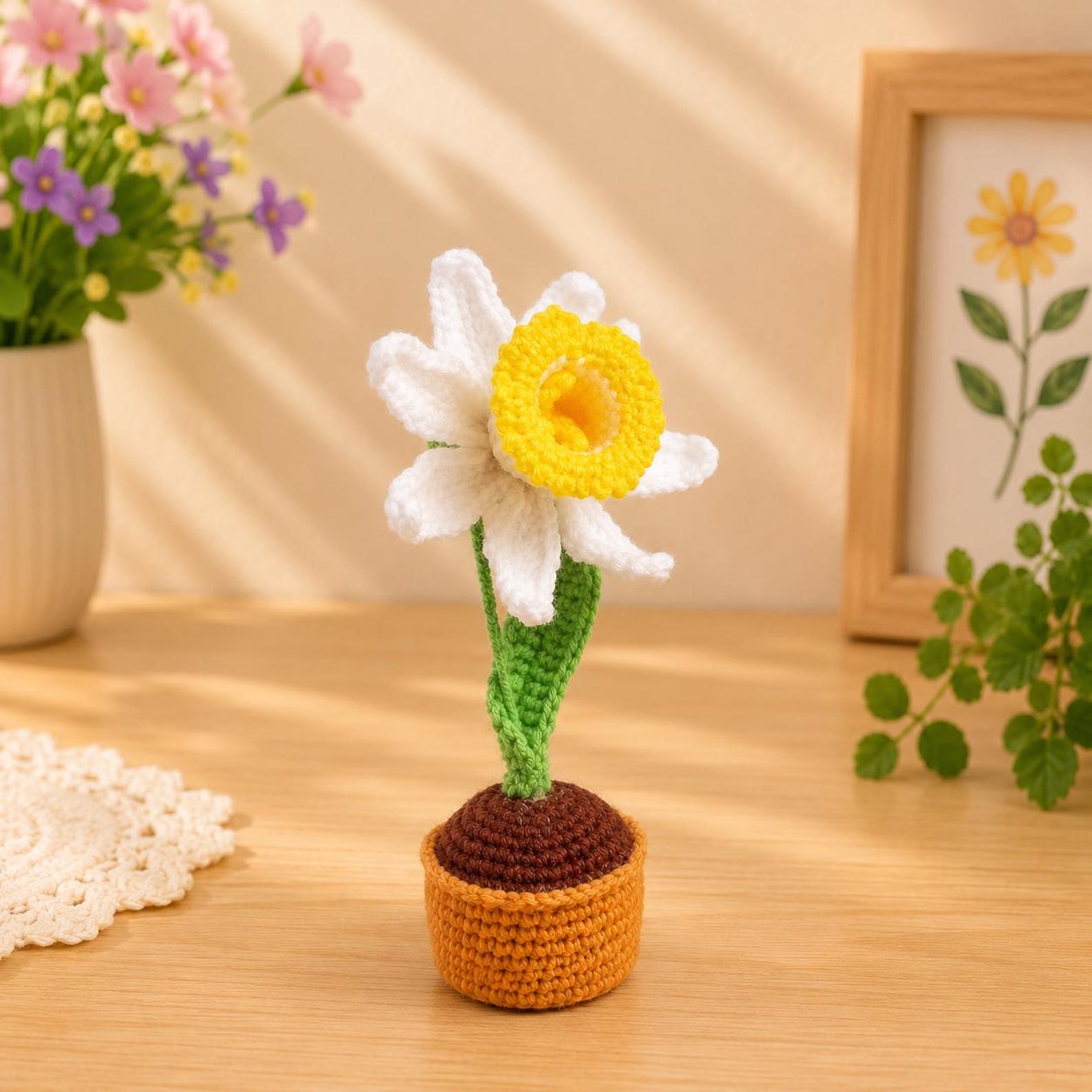 Crochet narcissus flower pot in soft pastel color variation displayed on a wooden shelf