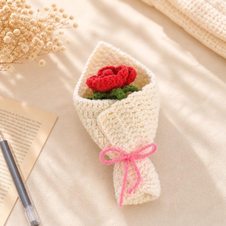 Close-up of a single crocheted rose showing layered spiral petal construction and stitch detail
