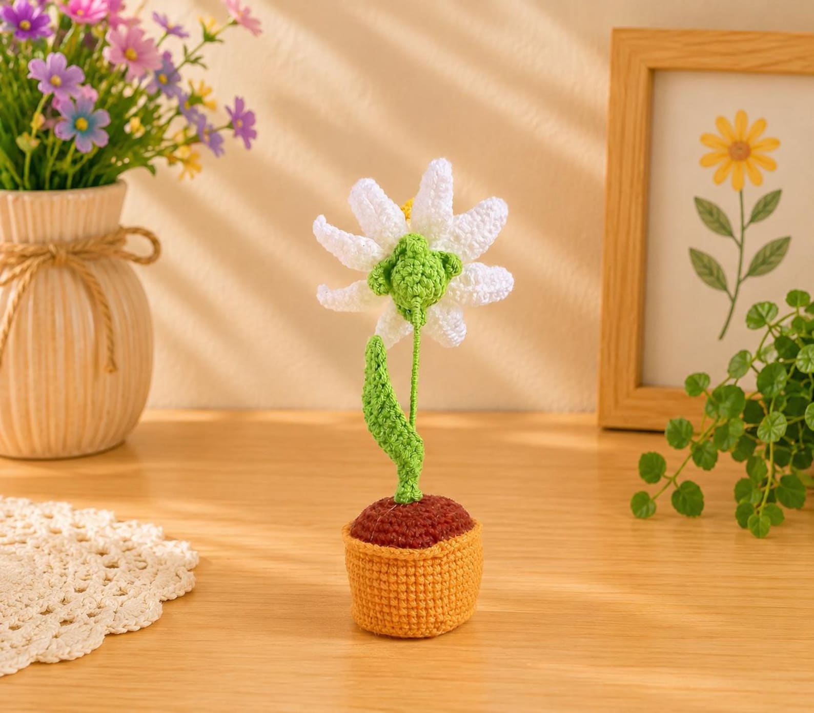 Crochet narcissus flower pot arrangement with wired stems and leaves shown from a side angle