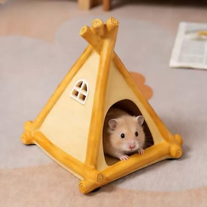 Könnte beinhalten: Ein kleiner, hellbrauner Hamster blickt aus einem gelb-cremefarbenen, tipi-förmigen Tierhaus. Das Haus hat ein kleines Fenster und dekorative Holz-Akzente. Das Fell des Hamsters ist hellbraun, und er scheint den Betrachter direkt anzusehen.