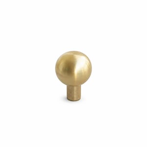 May include: A spherical brass cabinet knob with a smooth, polished metallic finish. The knob features a round ball-shaped head attached to a cylindrical base, showcasing a consistent golden-yellow tone and a reflective surface throughout the piece.