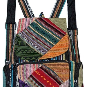 May include: A backpack featuring a patchwork design with various woven fabric patterns in colors including red, green, orange, purple, and blue. The bag includes adjustable shoulder straps, a top flap with a magnetic closure, and zippered pockets.