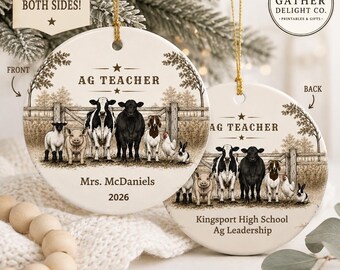 May include: Two round white ceramic ornaments with gold hanging strings. The front features a farm scene with a cow, pig, sheep, goat, chicken, and rabbit, text reading AG TEACHER, Mrs. McDaniels, and 2026. The back shows the same animals with AG TEACHER, Kingsport High School, and Ag Leadership.