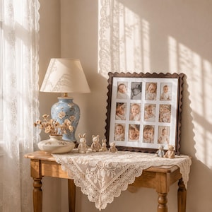 May include: A square dark wood scalloped picture frame containing a collage of twelve individual baby portraits, displayed alongside a blue floral ceramic lamp, a small cream vase with dried flowers, and several small animal figurines.