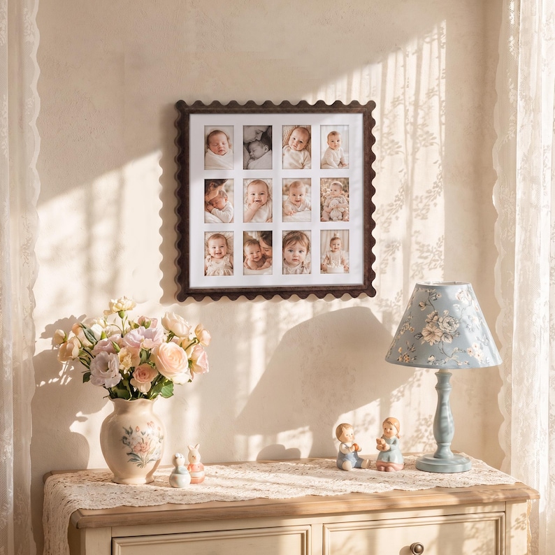 May include: A square wall-mounted collage picture frame with a dark brown scalloped edge, featuring twelve individual rectangular openings displaying black and white photographs of infants and young children arranged in a grid pattern.