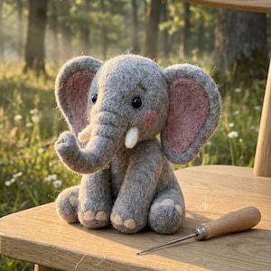 May include: A gray felt elephant doll with pink inner ears, sitting on a wooden chair. The elephant has a trunk, small tusks, and black eyes. A wooden-handled awl rests on the chair next to the elephant.