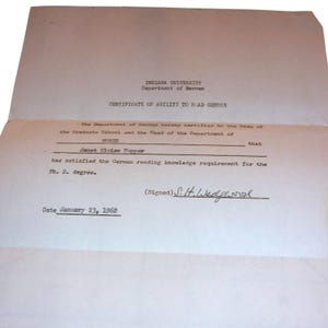 May include: A white paper certificate from Indiana University Department of German titled Certificate of Ability to Read German. It states Janet Eloise Tupper has satisfied the German reading knowledge requirement for the Ph.D. degree, dated January 23, 1962.