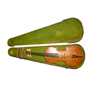 May include: A vintage violin rests inside an open, green velvet-lined case. The violin has a warm, brown finish with a black fingerboard and a detailed scroll. The case is rectangular with a curved top.