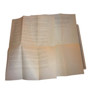 May include: A folded, off-white document titled "Handy Tips for the Parliamentarian" featuring black typewritten text. The paper has visible creases and is positioned next to a ruler showing measurements in inches along the right edge.