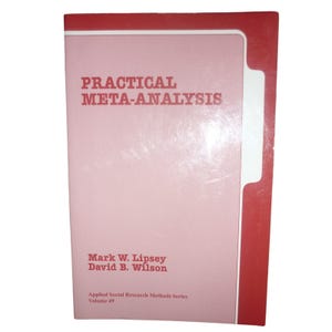 May include: A softcover book titled Practical Meta-Analysis by Mark W. Lipsey and David B. Wilson. The cover is light pink with a red border and white accent line. It is part of the Applied Social Research Methods Series, Volume 49.