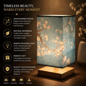 May include: A rectangular table lamp with a wooden base and a light blue shade featuring cherry blossom illustrations. The lamp has the text "TIMELESS BEAUTY, WARM EVERY MOMENT". The lamp is designed for bedroom, living room, reading, and relaxation.