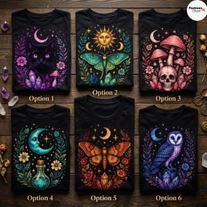May include: Six black t-shirts arranged in a grid, each featuring a distinct colorful graphic print. Designs include a cat with crystals, a sun and moth, a skull with mushrooms, a crescent moon with a potion bottle, a butterfly, and an owl.