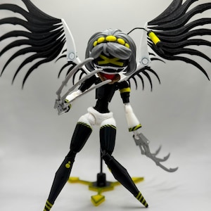 May include: A posable action figure featuring a character with grey hair, a black face with a yellow X-shaped visor, and large black wings. The figure has black and white limbs, yellow accents, and sharp, claw-like attachments on both hands.