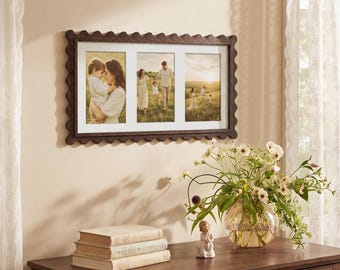 May include: A rectangular dark brown wooden picture frame with a scalloped edge design, featuring three vertical photo openings. The frame holds three separate photographs depicting family scenes in a grassy field during the golden hour.