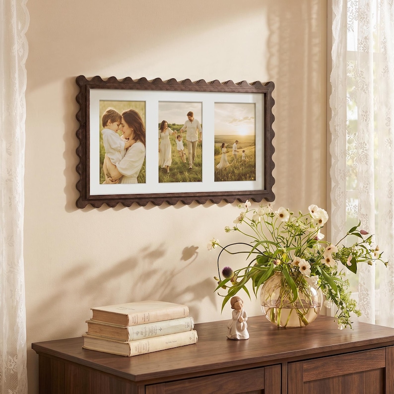 May include: A rectangular dark brown wooden picture frame with a scalloped edge design, featuring three vertical photo openings. The frame holds three separate photographs depicting family scenes in a grassy field during the golden hour.