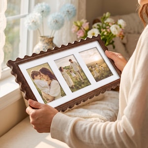 May include: A rectangular dark brown wooden picture frame with a scalloped edge and a white mat featuring three separate openings. The frame displays three distinct photographs of a family in an outdoor setting during the golden hour.
