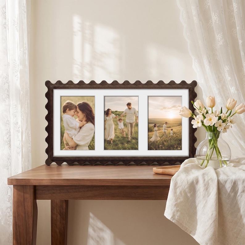 May include: A rectangular dark brown picture frame with a scalloped edge design featuring three vertical photo openings. The frame displays three separate photographs of a family in a grassy field at sunset, set against a white matting border.