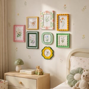 May include: A gallery wall arrangement of nine assorted picture frames in various colors and shapes, including rectangular, square, and scalloped designs. The frames contain botanical and insect illustrations, displayed on a wall with small floral decals.