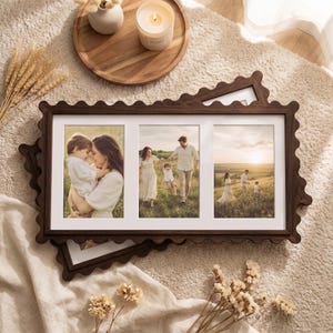 May include: A dark brown wooden triple photo frame with a scalloped edge design. The frame holds three vertical photographs featuring a family in a grassy field at sunset. The frame is rectangular with a white mat board surrounding each photo.