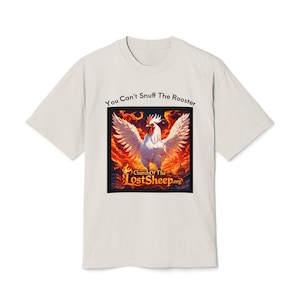 May include: Off-white t-shirt with the text "You Can't Snuff The Rooster" above a square graphic. The graphic features a white rooster with outstretched wings against a fiery background. The text "Church Of The LostSheep.org" is at the bottom.