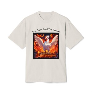 May include: Off-white t-shirt with the text "You Can't Snuff The Rooster" above a square graphic. The graphic features a white rooster with outstretched wings against a fiery background. The text "Church Of The LostSheep.org" is at the bottom.