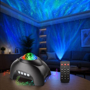 May include: A black dome-shaped light projector with a multi-colored lens, featuring control buttons on the front and a matching black remote control with various function buttons, casting a blue and green aurora effect with stars on the ceiling.