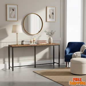 May include: A long, rectangular console table with a brown wood-grain surface and a black metal frame. The table features four thin legs and a central support bar, providing a stable base for the tabletop. It is positioned against a wall.
