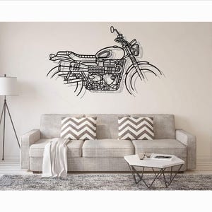 May include: A black metal wall art piece depicting the side profile of a motorcycle. The design features detailed outlines of the fuel tank, seat, engine, exhaust pipes, and wheels, creating a layered, linear silhouette mounted on a wall.