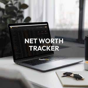 May include: A laptop displaying a financial dashboard with the text "NET WORTH TRACKER." The laptop is open on a white desk, next to a notebook, sunglasses, and a coffee cup. The screen shows financial data.