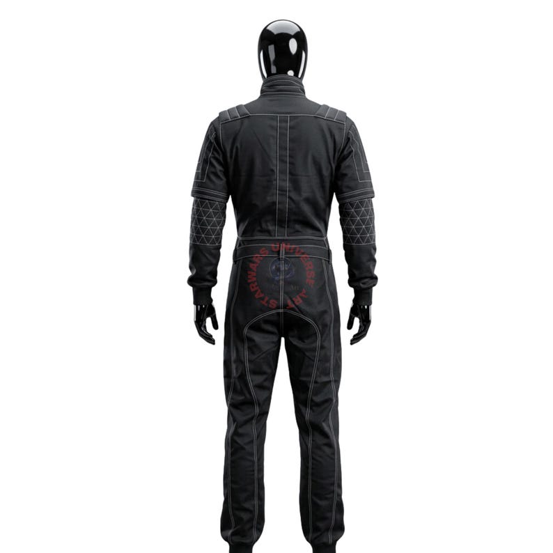 May include: A black jumpsuit featuring white contrast stitching, a high collar, and long sleeves with a geometric triangular pattern on the forearms. The garment includes a belt at the waist and a circular logo with the text STAR WARS UNIVERSE ART.