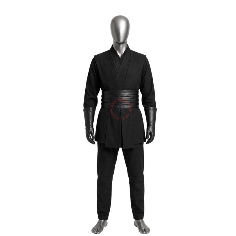 May include: A black costume set featuring a long-sleeved tunic with a wrap-style V-neckline, matching black trousers, and a wide, multi-layered black leather-look belt with silver-toned studs. The outfit includes long black gauntlet-style gloves.