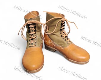 Botas de lona y cuero color camel con cordones, estilo militar, suela con tachuelas, calzado robusto de estilo clásico.