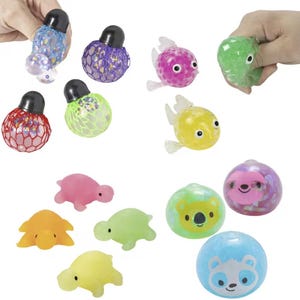 May include: A collection of various sensory toys including mesh-covered squeeze balls in red, purple, and green, translucent fish figures in pink and yellow, small solid-colored turtle figurines, and round squeeze balls featuring koala, sloth, and panda faces.