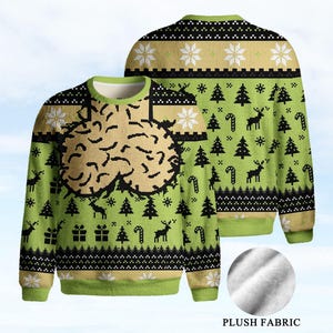 May include: A long-sleeve crew neck sweater in lime green, black, and beige. The front features a large, textured beige graphic. The overall pattern includes black silhouettes of reindeer, Christmas trees, candy canes, and gift boxes.