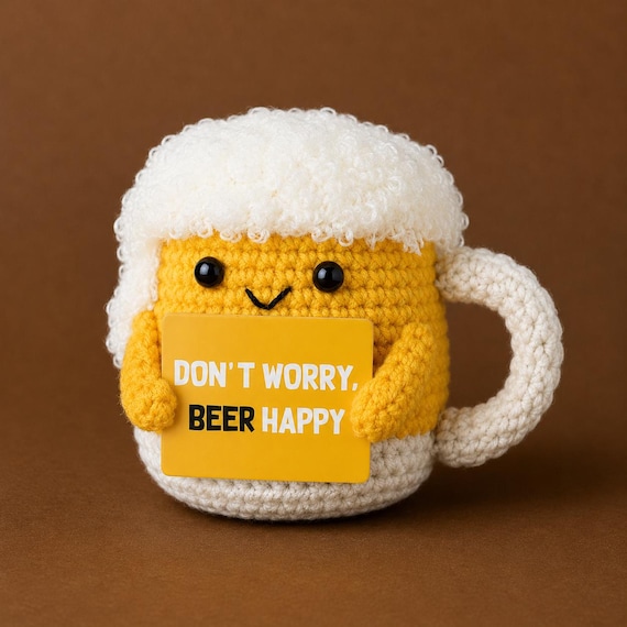 A tiny crocheted beer mug plush with a perfect foam head — the handcraft detail on something this absurdly specific is what makes it.