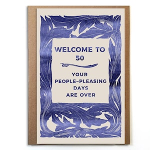 May include: A blue and white greeting card with a decorative border and the text "Welcome to 50. Your people-pleasing days are over."