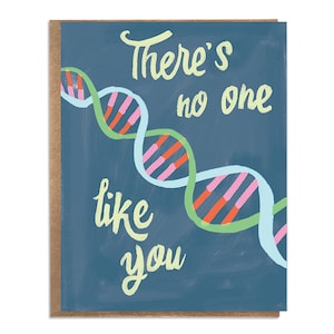 May include: A blue card with a white and green DNA strand design. The card has the text "There's no one like you" in yellow.