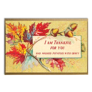 May include: A Thanksgiving-themed greeting card with a fall foliage design. The card features a white rectangle with the text "I am thankful for you and mashed potatoes with gravy".