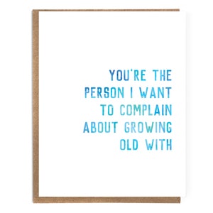 May include: A card with a blue and white gradient design that says "You're the person I want to complain about growing old with."