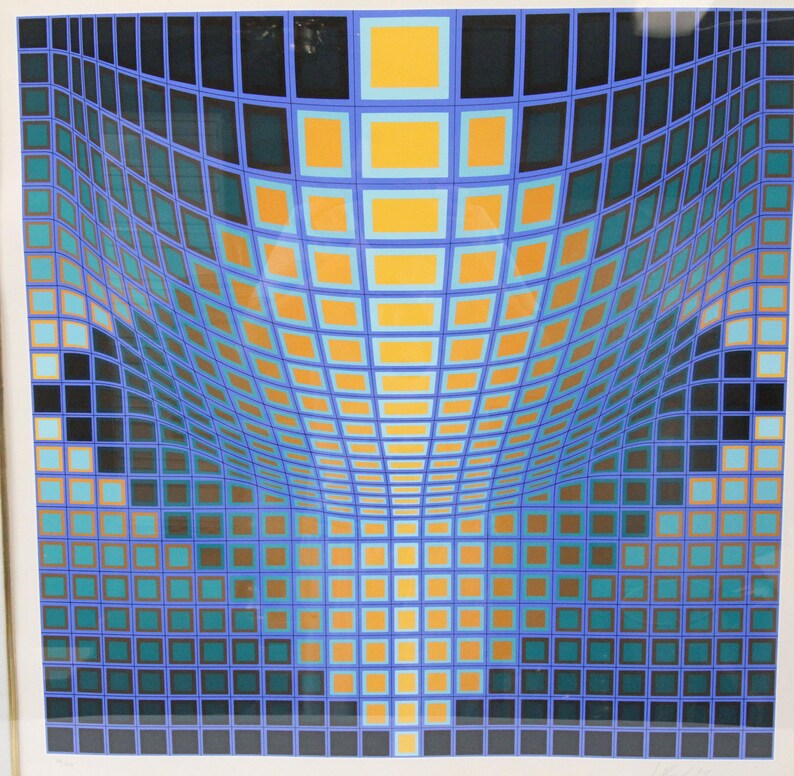 May include: Abstract geometric art print featuring a grid pattern with a curved perspective. The artwork uses a palette of blue, teal, orange, and black squares, creating a visual illusion of depth and movement. The print is framed in a white border.