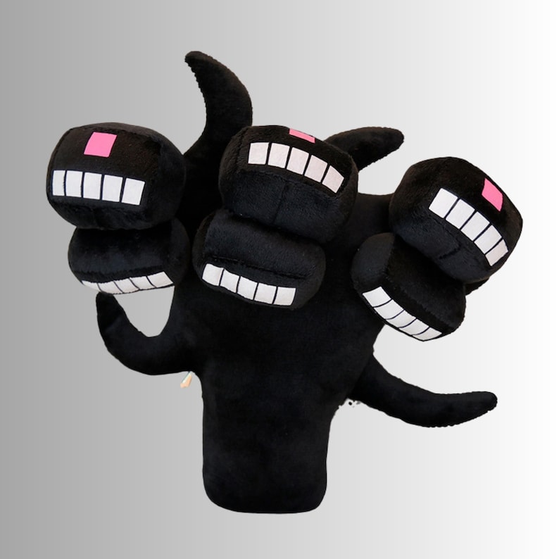 May include: A black plush toy of a multi-headed creature with blocky heads. Each head has a white-toothed grin and a pink square. The toy has a soft, plush texture and a whimsical design, suitable for children.
