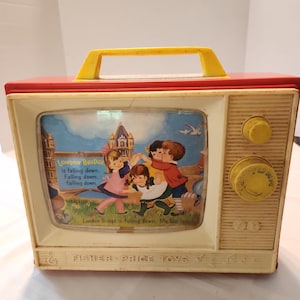 May include: A vintage Fisher-Price musical television toy with a red frame, yellow handle, and cream-colored front panel. The screen displays an illustration of children playing with the text London Bridge is falling down, falling down.