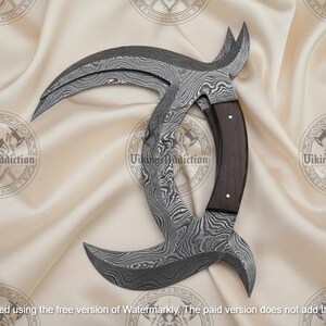 May include: A curved, Damascus steel blade with a dark wood handle. The blade has a unique, crescent shape with a textured pattern. The handle is a dark brown color. The overall design is intricate and detailed.